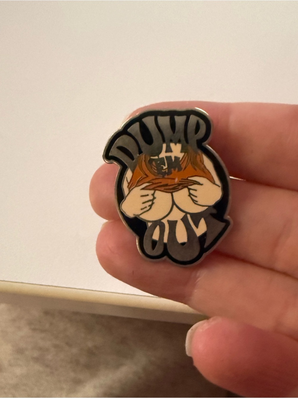 Dump Em Out novelty enamel pin